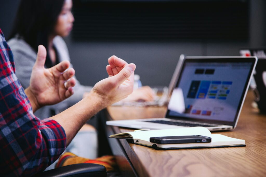 gesturing hands in front of laptop screen Managing Anxiety at Work featured image